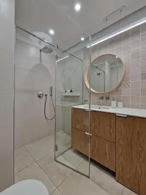 a bathroom with a shower and a sink and a mirror at New Funcional Easy Stay High Standard Kraków apartment free garage parking in Kraków