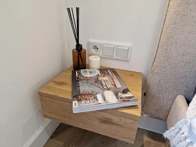 a table with a magazine and a book on it at New Funcional Easy Stay High Standard Kraków apartment free garage parking in Kraków