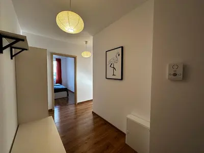 a living room with a couch and a light at Tresor Pułaskiego Apartments in Kraków