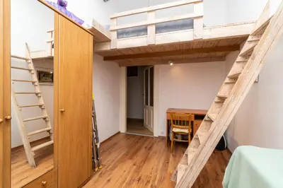 a room with a loft bed and a desk at Artapartamenty in Kraków