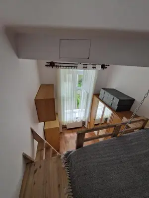 a bedroom with a bed and a large window at Artapartamenty in Kraków