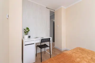 a small white desk with a chair in a room at Cosy and Comfortable Apartment in Krakow by Noclegi Renters in Kraków