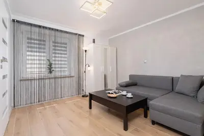 a living room with a couch and a coffee table at Cosy and Comfortable Apartment in Krakow by Noclegi Renters in Kraków