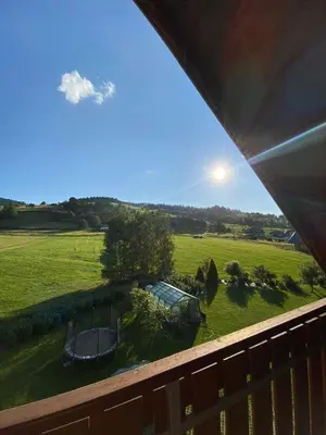 a view of a yard from the deck of a house at PrzyStań w Gorcach in Konina