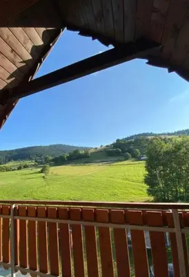 a view of a green field from a bench at PrzyStań w Gorcach in Konina