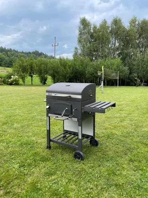 a grill sitting in the grass in a field at PrzyStań w Gorcach in Konina