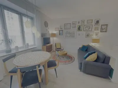a living room with a table and a couch at Snow White Apartment in Kraków