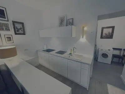 a white kitchen with a sink and a washing machine at Snow White Apartment in Kraków