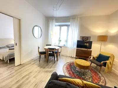 a living room with a couch and a table at Snow White Apartment in Kraków
