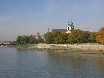 a large body of water with people walking on the side at Snow White Apartment in Kraków