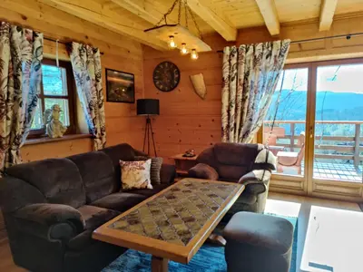 a living room with a couch and a table at Zacisze na Wzgórzu in Zawoja