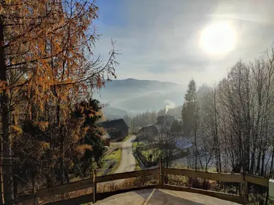 a view of a road with the sun in the sky at Zacisze na Wzgórzu in Zawoja