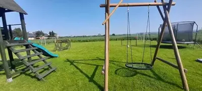 an empty playground with a swing and a slide at Relax domki Zator in Zator