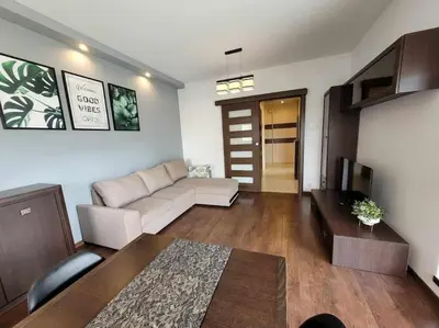 a living room with a couch and a table at Apartament Dark Chocolate 4 persons Down Town in Kraków