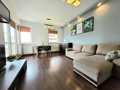 a living room with a couch and a table at Apartament Dark Chocolate 4 persons Down Town in Kraków
