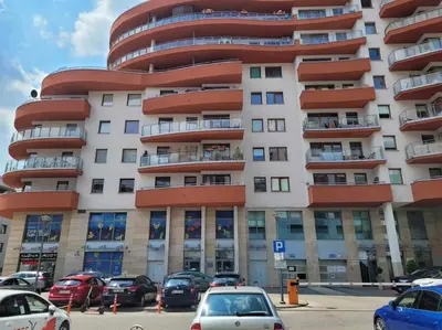 a large building with cars parked in front of it at Apartament Dark Chocolate 4 persons Down Town in Kraków