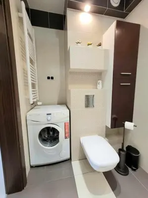 a bathroom with a washing machine and a toilet at Apartament Dark Chocolate 4 persons Down Town in Kraków