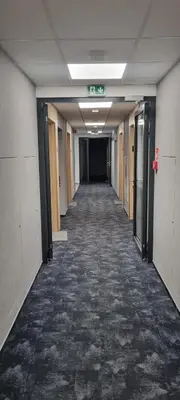 an empty hallway in an office building with a long corridor at Apartament Xavier II Kraków in Kraków