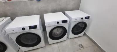 three washing machines sitting next to each other at Apartament Xavier II Kraków in Kraków