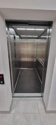 a hallway with a walk in shower in a building at Apartament Xavier II Kraków in Kraków