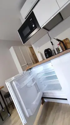 a refrigerator with its door open in a kitchen at Apartament Xavier II Kraków in Kraków