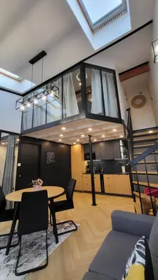 a living room with a table and a staircase at Old Town Apartment, Starowiślna in Kraków