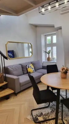a living room with a couch and a table at Old Town Apartment, Starowiślna in Kraków