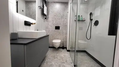 a bathroom with a toilet and a sink and a shower at Old Town Apartment, Starowiślna in Kraków
