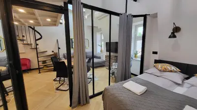 a bedroom with a bed and a dining room at Old Town Apartment, Starowiślna in Kraków