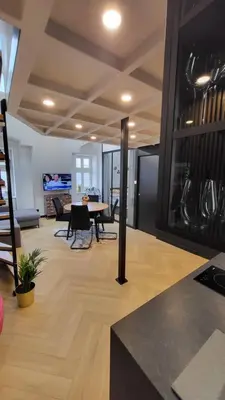 a kitchen and living room with a table and chairs at Old Town Apartment, Starowiślna in Kraków