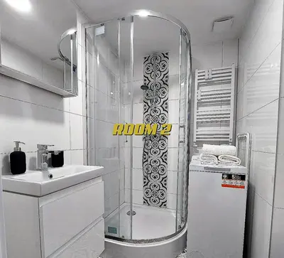 a glass shower in a bathroom with a sink at Old Town Stage The Studio Suite Quartet in Kraków