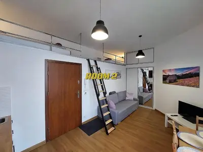 a living room with a ladder in a room at Old Town Stage The Studio Suite Quartet in Kraków