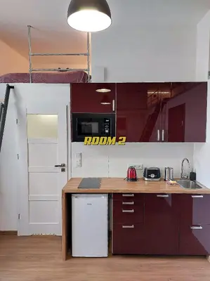 a kitchen with brown cabinets and a counter top at Old Town Stage The Studio Suite Quartet in Kraków