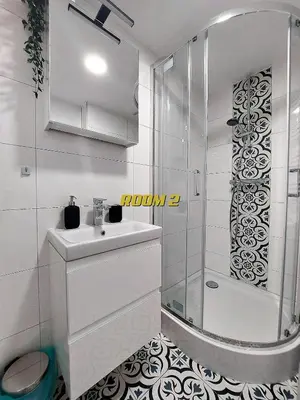 a white bathroom with a shower and a sink at Old Town Stage The Studio Suite Quartet in Kraków