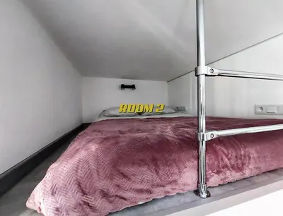 a bed in a white room with a sign on it at Old Town Stage The Studio Suite Quartet in Kraków