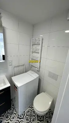 a white bathroom with a toilet and a sink at Old Town Stage The Studio Suite Quartet in Kraków