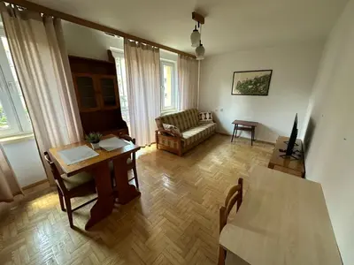 a living room with a couch and a table at Przestronny apartament w centrum miasta - Mszana M11 in Mszana Dolna