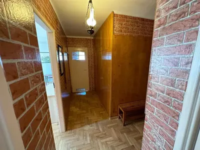 a hallway of a home with a brick wall at Przestronny apartament w centrum miasta - Mszana M11 in Mszana Dolna