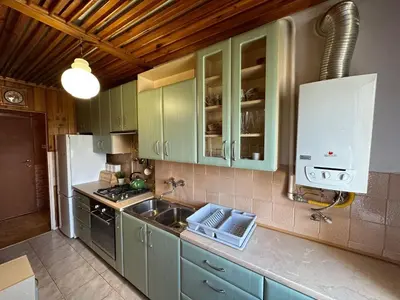 a kitchen with green cabinets and a sink at Przestronny apartament w centrum miasta - Mszana M11 in Mszana Dolna