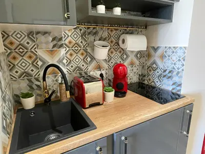 a kitchen counter with a sink and a toaster at Aparthotel Cracow in Kraków
