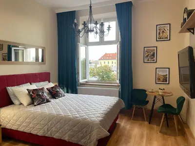 a bedroom with a large bed and a window at Aparthotel Cracow in Kraków