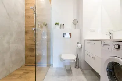a white bathroom with a toilet and a shower at Perfect Stay Zabłocie 35 in Kraków