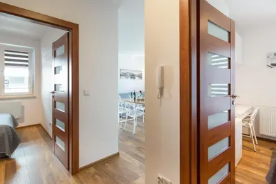 a door leading into a room with a bedroom at Perfect Stay Zabłocie 35 in Kraków