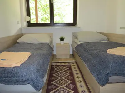 two beds sitting next to each other in a room at AirSpot Balice in Cholerzyn