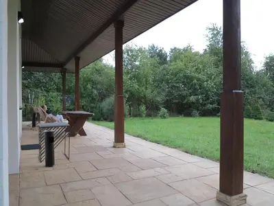 a person sitting on a bench under a pavilion at AirSpot Balice in Cholerzyn