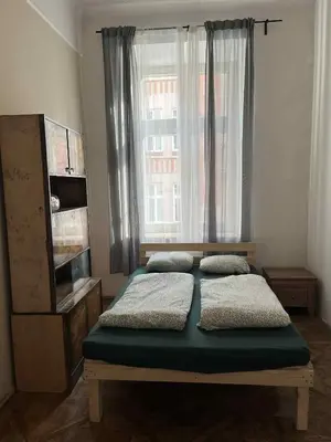 two twin beds in a bedroom with a window at Old Town Rooms Wielopole in Kraków