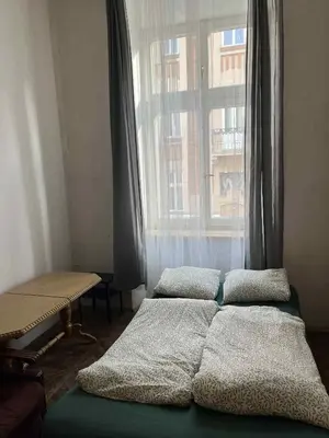a bathroom with a tub and a glass shower at Old Town Rooms Wielopole in Kraków