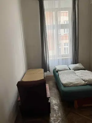 two beds in a room with an archway at Old Town Rooms Wielopole in Kraków