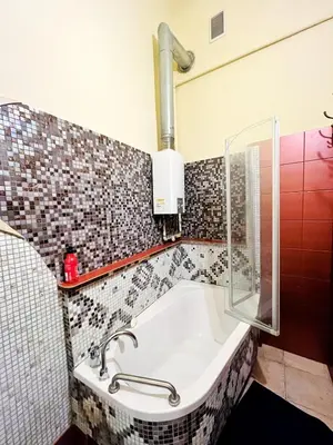 a bed sitting in a room with a window at Old Town Rooms Wielopole in Kraków