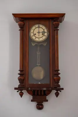 a grandfather clock hanging on a wall at Spacious Retro Apartment in the Center of Cracow by Noclegi Renters in Kraków